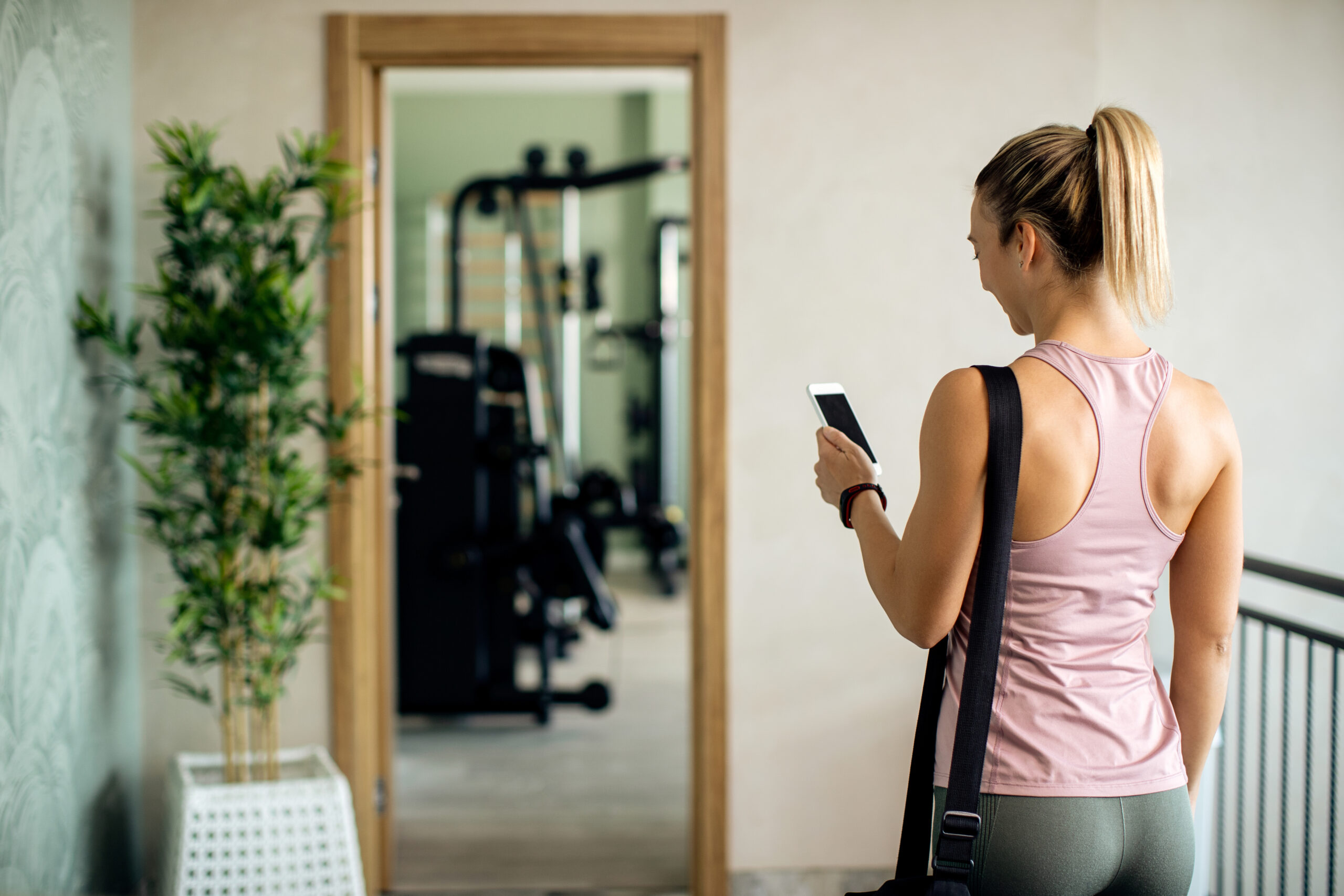 Athletic woman walking through the hallway of a gym